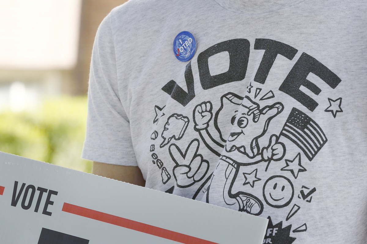 epa08797087 A voter shows his spirit as voters headed to the poles in Dallas, Texas USA, 03 November 2020. Americans vote on Election Day to choose between re-electing Donald J. Trump or electing Joe  ...