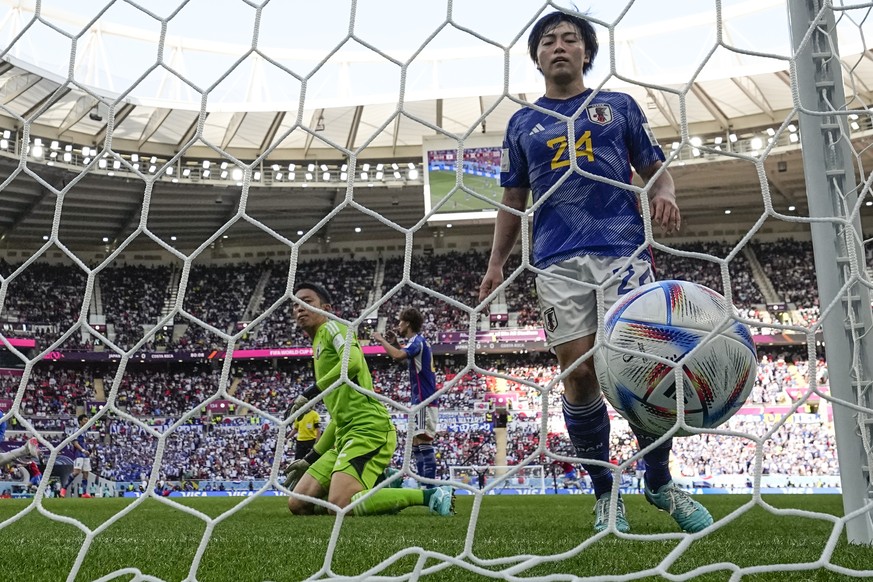 Japan&#039;s goalkeeper Shuichi Gonda and Yuki Soma look at the ball getting into the net for Costa Rica&#039;s Keysher Fuller to score his side&#039;s opening goal, during the World Cup, group E socc ...
