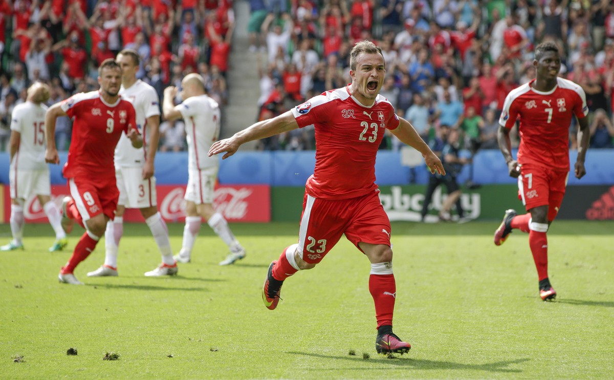 Switzerland's Xherdan Shaqiri, center, celebrates after scoring his sides first goal during the Euro 2016 round of 16 soccer match between Switzerland and Poland, at the Geoffroy Guichard stadiu ...