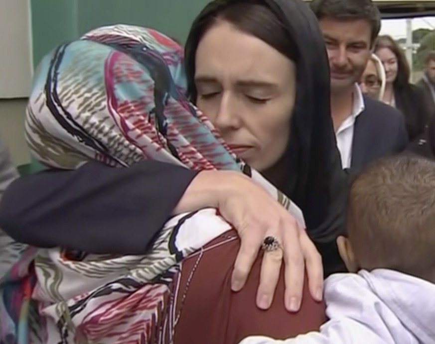 In this image made from video, New Zealand&#039;s Prime Minister Jacinda Ardern, center, hugs and consoles a woman as she visited Kilbirnie Mosque to lay flowers among tributes to Christchurch attack  ...