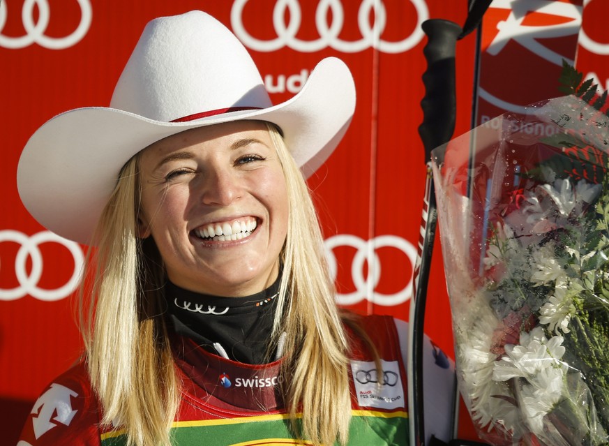 Switzerland's Lara Gut celebrates her first place finish on the podium following the women's World Cup Super-G ski race in Lake Louise, Alberta, Sunday, Dec. 7, 2014. (AP Photo/The Canadian  ...