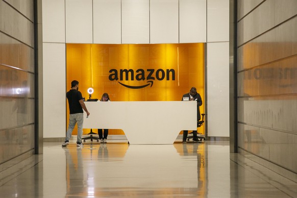 epa10941440 People are seen at Amazon's New York office, New York, US, October 26, 2023. Amazon.com is expected to report its quarterly results on October 26.  The company last posted its question...