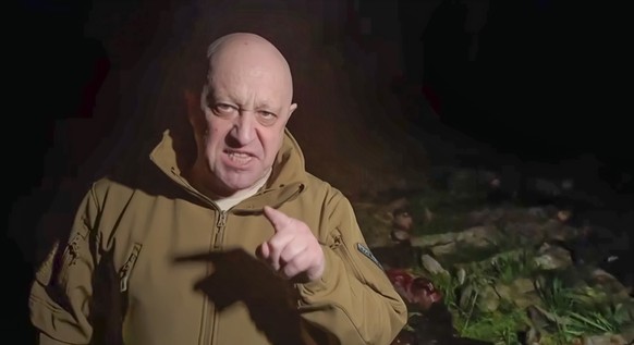 In this handout image taken from a video released by Prigozhin Press Service on Friday, May 5, 2023, head of Wagner Group Yevgeny Prigozhin stands in front of multiple bodies lying on the ground in an ...