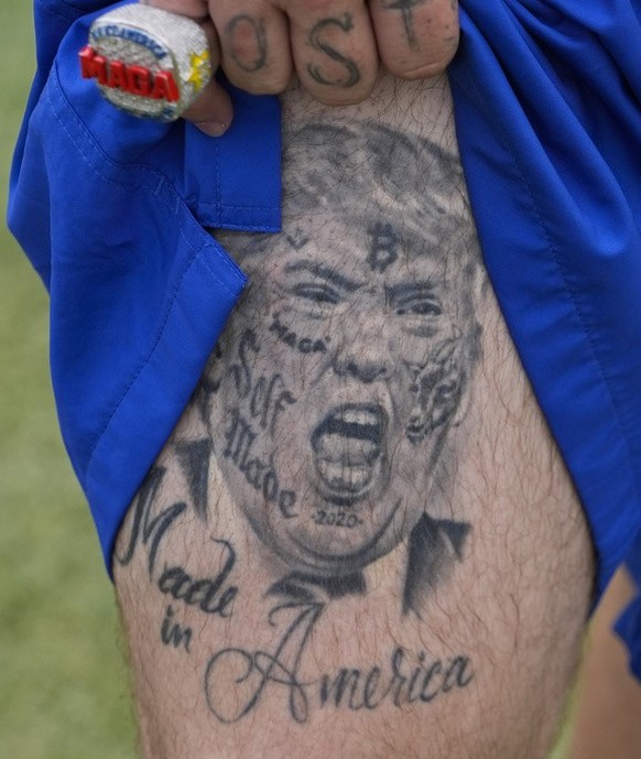 A supporter shows off a tattoo before Republican presidential candidate former President Donald Trump speaks at a campaign rally at Trump National Doral Miami, Tuesday, July 9, 2024, in Doral, Fla. (A ...