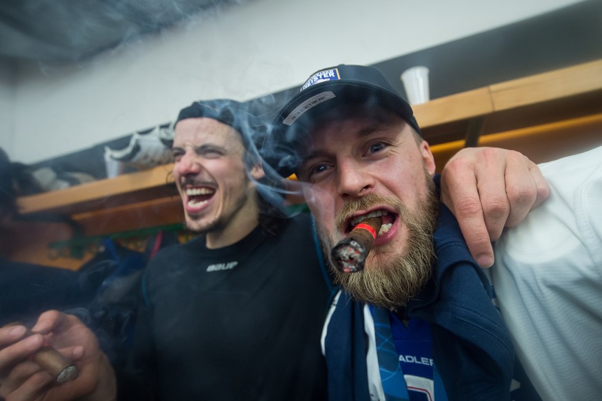 Zurich's player Roman Wick, left, and Zurich's player Fredrik Pettersson, right, celebrate winning the Swiss championship title, after the seventh match of the playoff final of the National ...