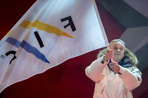 epa07343588 Gian Franco Kasper, president of the International Ski Federation (FIS), waves a FIS flag on stage during the opening ceremony of the FIS Alpine Skiing World Championships in Are, Sweden,  ...