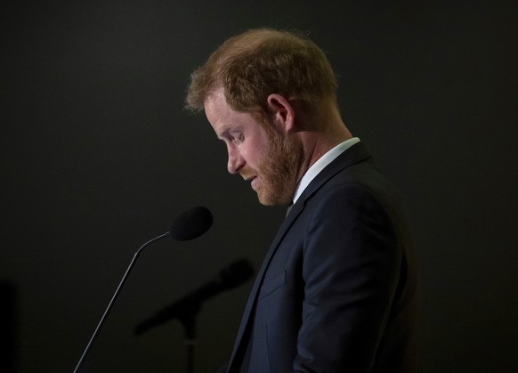 Prince Harry speaks during the "One more year to go" Invictus Games dinner in Vancouver, British Columbia, Friday, Feb. 16, 2024. (Ethan Cairns/The Canadian Press via AP)