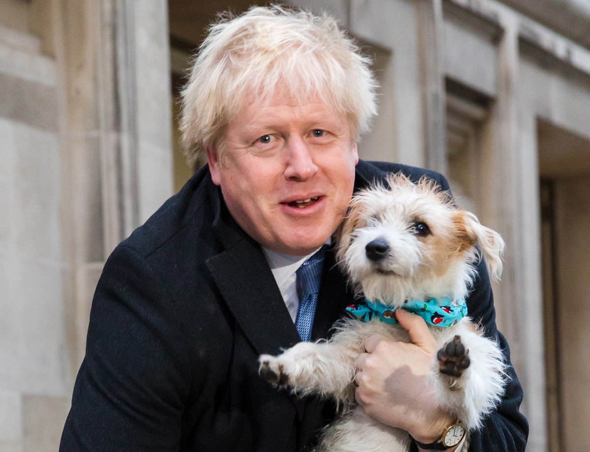 epaselect epa08064553 Britain's Prime Minster Boris Johnson leaves the polling station after casting his vote with his dog Dylan, during the general election in London, Britain, 12 December 2019. ...