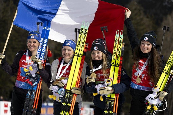 Gold medalists of team France with Julia Simon, Justine Braisaz-Bouchet, Oceane Michelon, and Lou Jeanmonnot, from left, celebrate during the medal ceremony after the women?s relay race at the IBU Bia ...