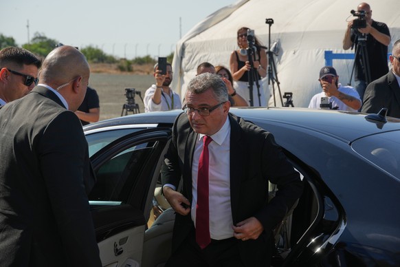 Turkish Cypriot leader Tufan Erhurman arrives for the meeting with Cyprus' President Nikos Christodoulides, left, at a U.N. compound in the Nicosia airport area, inside the United Nations-control ...
