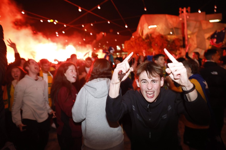 Football World Cup Australia Reax A flare is lit in the background as Socceroos fans celebrate Australia's goal as they watch Australia play Denmark in the FIFA World Cup, WM, Weltmeisterscha ...