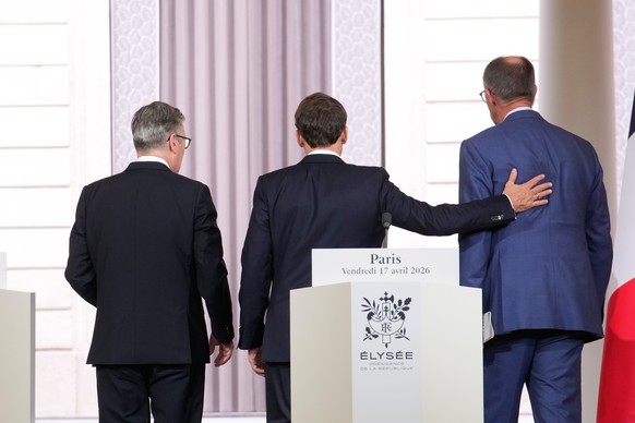 Britain's Prime Minister Keir Starmer, left, France's President Emmanuel Macron, center, and German Chancellor Friedrich Merz leave after they gave a statement at the end of an international ...