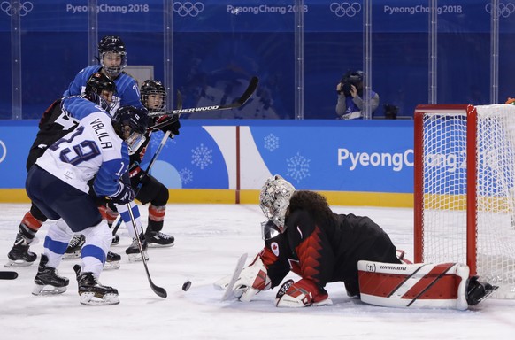 Riikka Valila, of Finland, scores a goal against goalie Shannon Szabados (1), of Canada, during the third period of the preliminary round of the women&#039;s hockey game at the 2018 Winter Olympics in ...