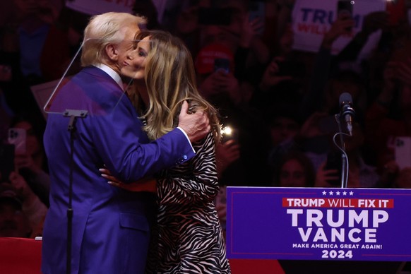 epa11688277 Former US President and Republican presidential candidate Donald Trump (L), embraces former First Lady Melania Trump (R) as he takes the stage during a rally at Madison Square Garden in Ne ...