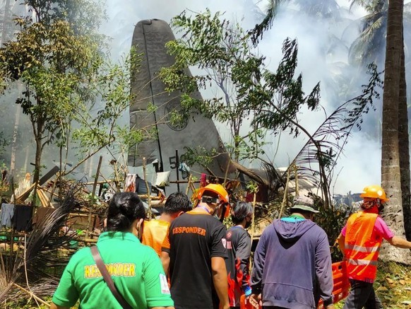 THIS CORRECTS THE NAME OF THE PROVINCE TO SULU, INSTEAD OF JOLO - In this photo released by the Joint Task Force - Sulu, rescuers search for bodies from the site where a Philippine military C-130 plan ...