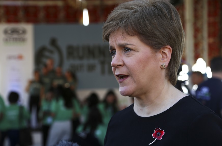 FILE - Scotland's First Minister Nicola Sturgeon speaks to members of the media at the finish line of the Running Out Of Time climate relay, which arrived from Glasgow, Scotland, after 40 days through ...