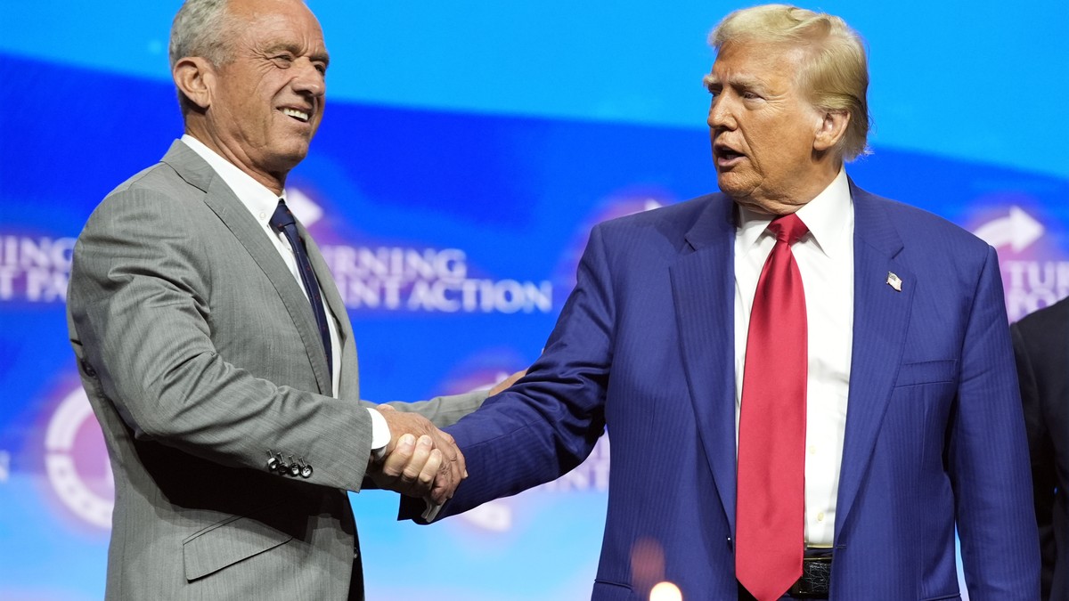 Republican presidential nominee former President Donald Trump shakes hands with Robert F. Kennedy Jr., at a Turning Point Action campaign rally, Wednesday, Oct. 23, 2024, in Duluth, Ga. (AP Photo/Alex ...
