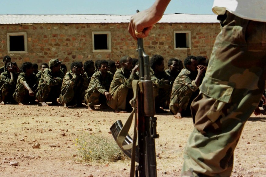 File - In this Feb. 10, 1999 file photo, an Eritrean soldier guards Ethiopian prisoners of war near Asmara, Eritrea. Qatar and the Arab nations now allied against it have made inroads in the Horn of A ...