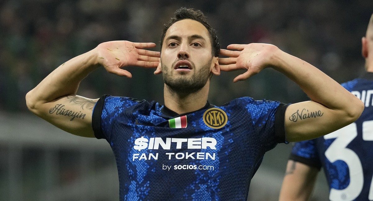 Inter Milan's Hakan Calhanoglu, celebrates after scoring on a penalty kick his side's first goal during the Serie A soccer match between AC Milan and Inter Milan at the San Siro stadium, in  ...