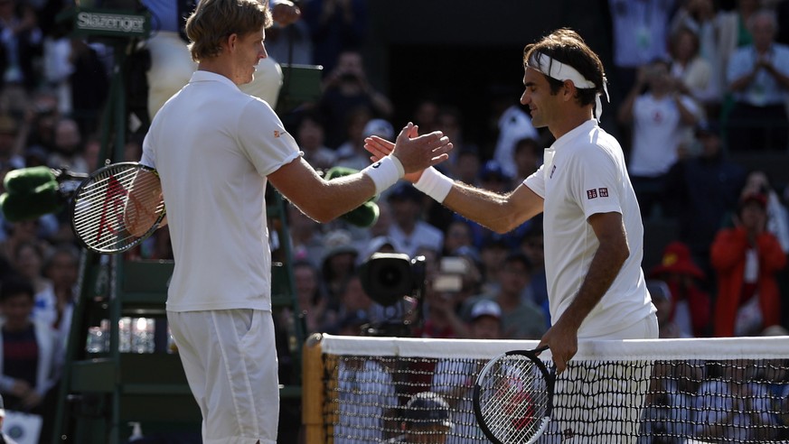 epa06880977 Kevin Anderson of South Africa (L) at the net with Roger Federer of Switzerland whom he defeated in their quarter final match during the Wimbledon Championships at the All England Lawn Ten ...