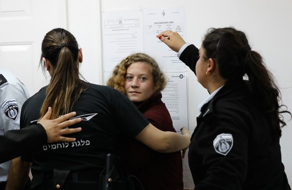 epa06399654 17 year old Palestinian Ahed Tamimi (C), a campaigner against Israel&#039;s occupation, appears at a military court at the Israeli-run Ofer prison in the West Bank village of Betunia, 20 D ...