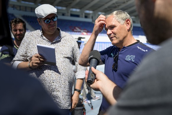 Switzerland&#039;s national soccer teams director Pierluigi Tami. right, answers questions from journalists before a training session of the Switzerland&#039;s football national team at the Restelo st ...