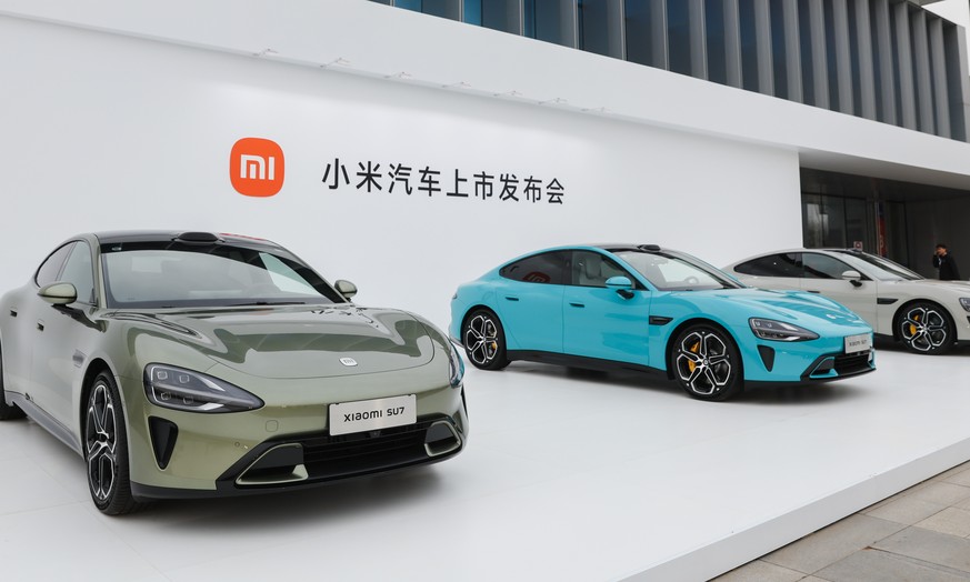 epa11248083 Xiaomi SU7 electric cars displayed at Beijing Etrong International Exhibition and Convention Center, in Beijing, China, 28 March 2024. Xiaomi released its new electric car product &#039;SU ...