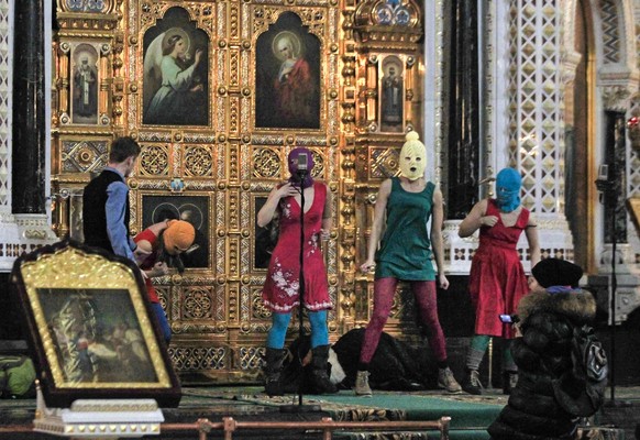 FILE - In this Tuesday, Feb. 21, 2012 file photo members of the Russian radical feminist group chant a prayer against Russian Prime Minister Vladimir Putin at the Christ the Saviour Cathedral in Mosco ...