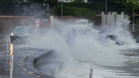 Traffic attempts to dodge large waves as they drive around a waterfront road in Lower Hutt, Wellington, New Zealand, Thursday, July 13, 2017. A powerful storm has caused further chaos as it makes it w ...