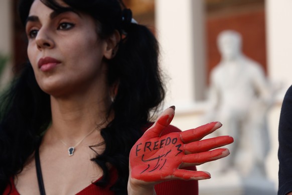 epa10218313 An Iranian woman living in Greece takes part in a protest over the death of young Iranian woman Mahsa Amini, who died last week after being arrested in Tehran for not wearing her hijab app ...