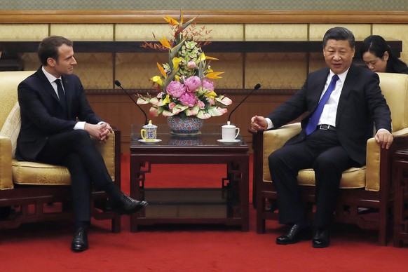 French President Emmanuel Macron, left, talks with Chinese President Xi Jinping during a meeting at the Diaoyutai State Guesthouse in Beijing, Monday, Jan. 8, 2018. Macron said he will ask Chinese lea ...