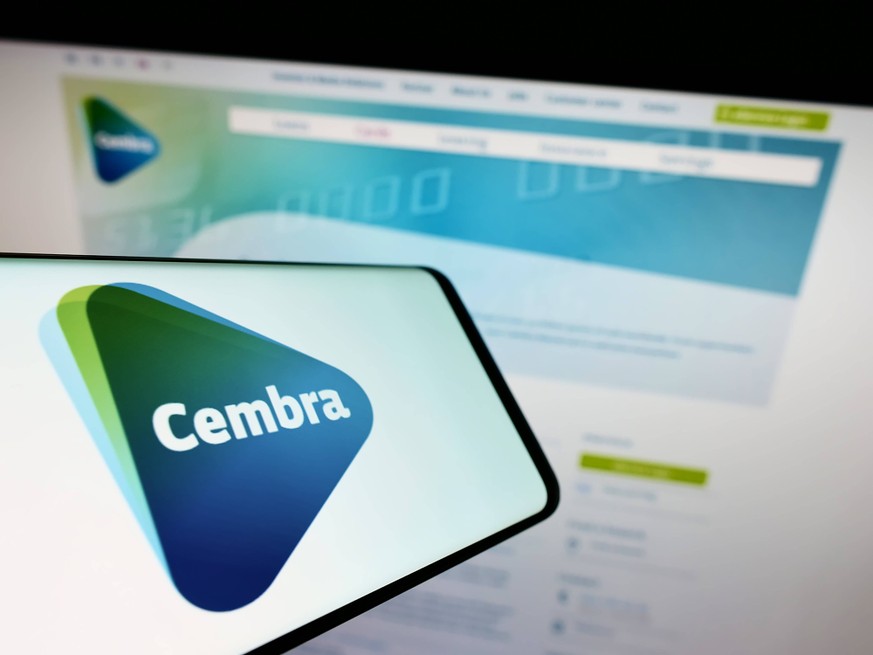 Smartphone with logo of Swiss financial company Cembra Money Bank AG on screen in front of website. Stuttgart, Germany - 05-22-2022: Smartphone with logo of Swiss financial company Cembra Money Bank A ...
