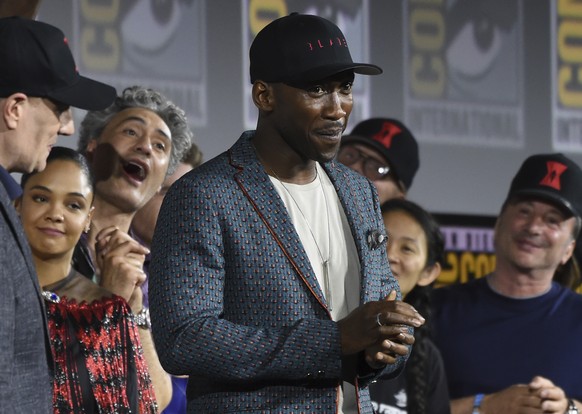 Mahershala Ali, center, wears a hat to promote his new movie &quot;Blade&quot; at the Marvel Studios panel on day three of Comic-Con International on Saturday, July 20, 2019, in San Diego. (Photo by C ...