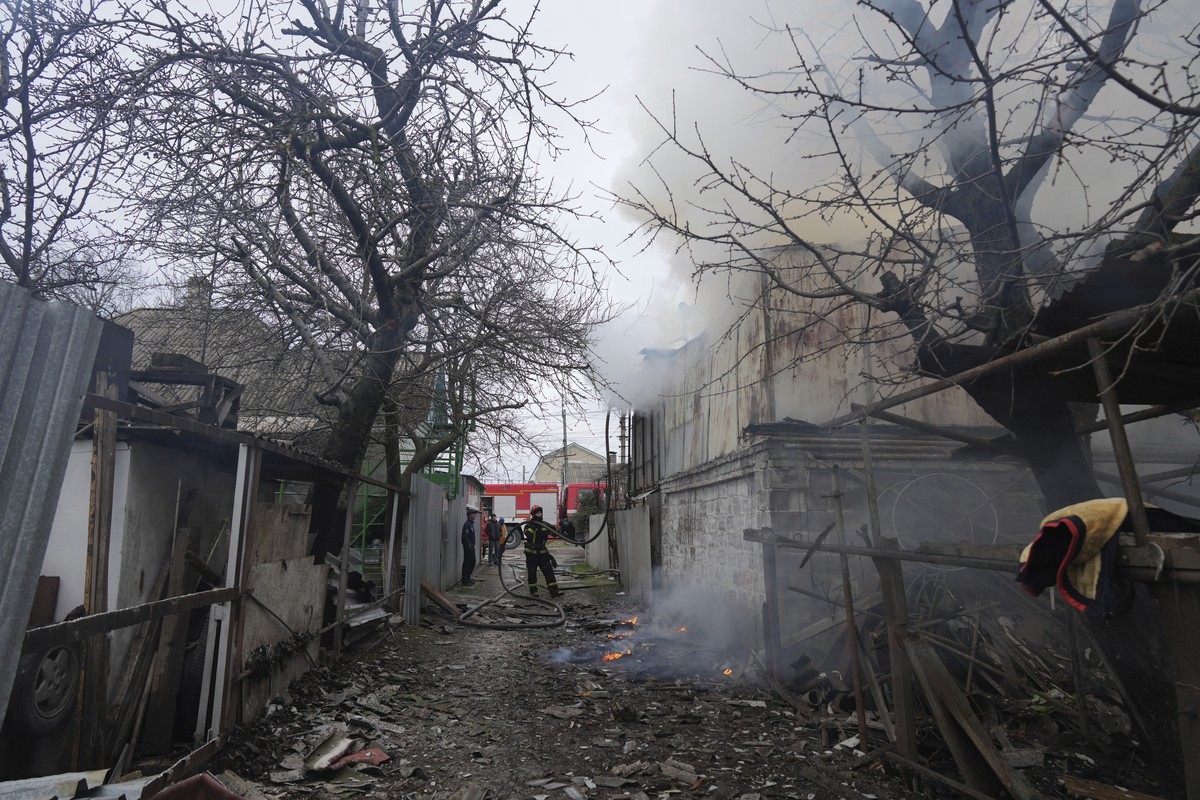 A firefighter works amongst debris in the aftermath of Russian shelling, in Mariupol, Ukraine, Thursday, Feb. 24, 2022. Russia has launched a barrage of air and missile strikes on Ukraine early Thursd ...