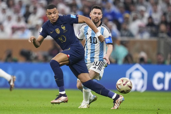 France&#039;s Kylian Mbappe and Argentina&#039;s Lionel Messi go for the ball during the World Cup final soccer match between Argentina and France at the Lusail Stadium in Lusail, Qatar, Sunday, Dec.1 ...