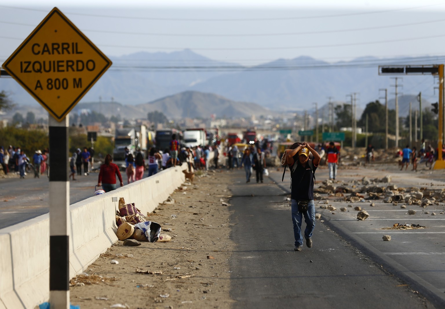 A man walks along the Pan-American North Highway where supporters of ousted Peruvian President Pedro Castillo have blocked the road, in Chao, Peru, Wednesday, Dec. 14, 2022. Peru&#039;s new government ...