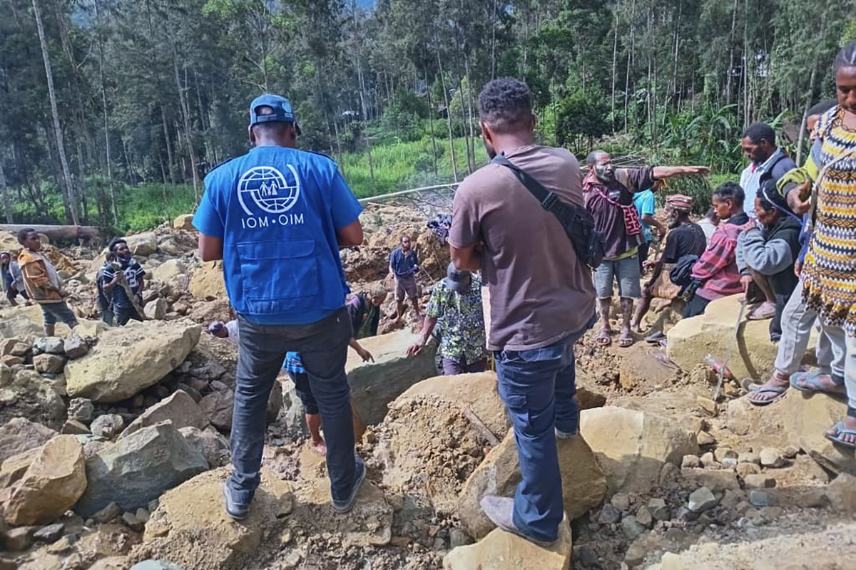 Villagers search through a landslide in Yambali village, in the Highlands of Papua New Guinea, Sunday, May 26, 2024. The International Organization for Migration feared Sunday the death toll from a ma ...