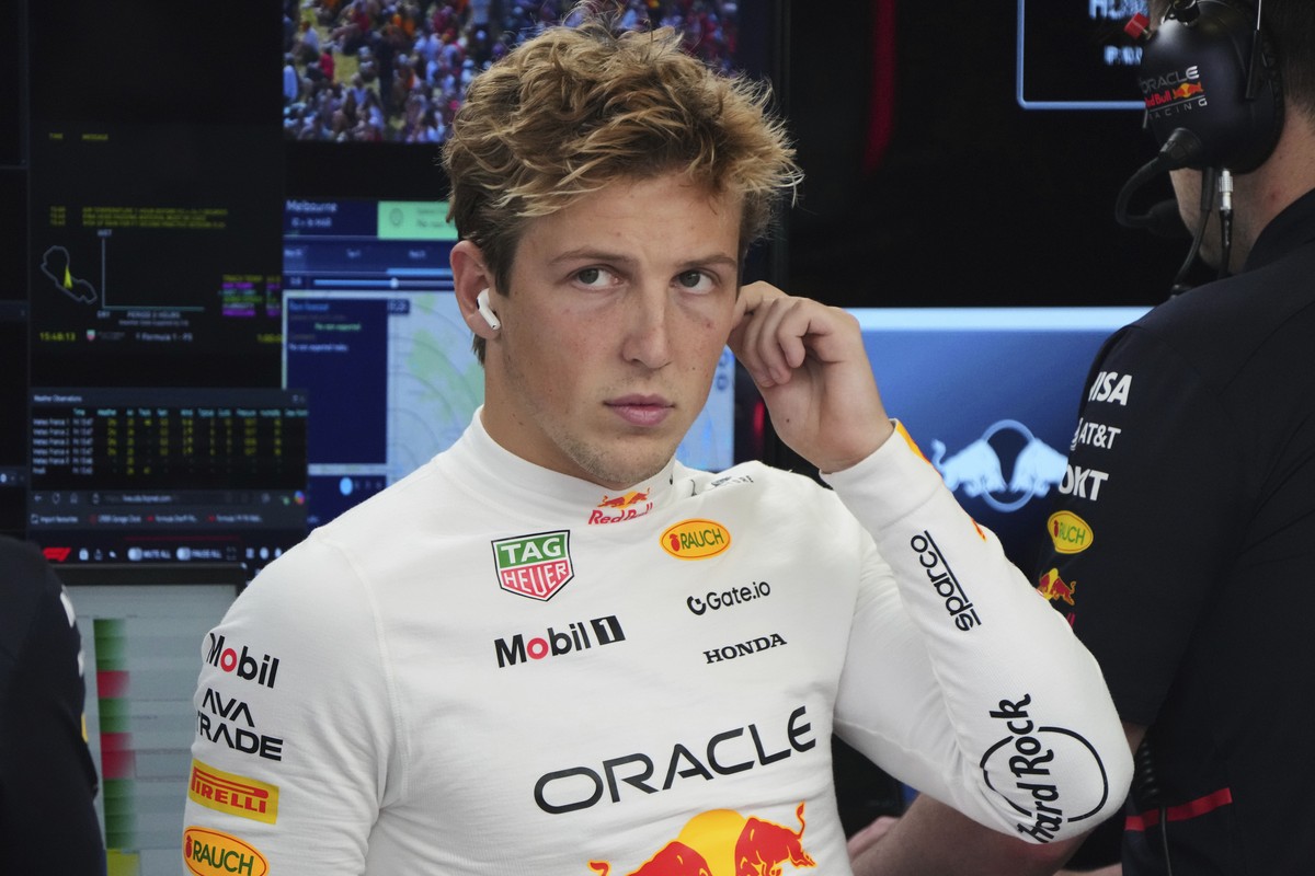 Red Bull driver Liam Lawson of New Zealand reacts in his team garage during the second practice session for the Australian Formula One Grand Prix at Albert Park, in Melbourne, Australia, Friday, March ...