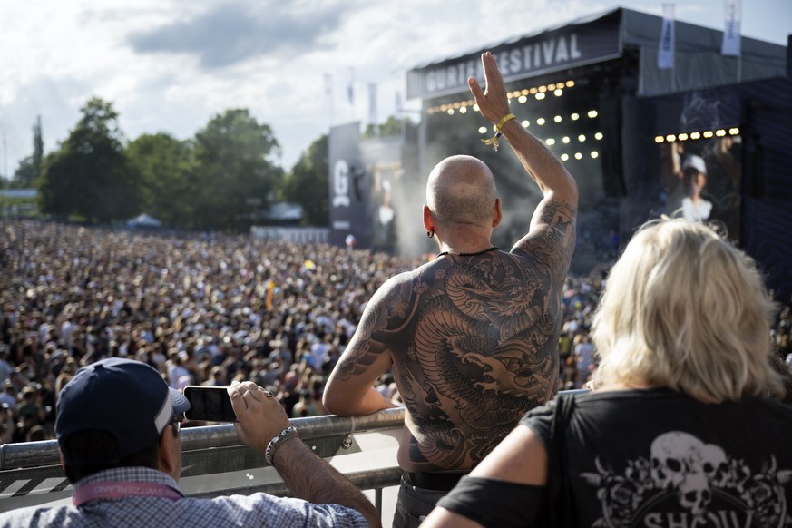 Festival goers enjoy a concert front of the main stage at the 40th Gurtenfestival edition, in Bern, Switzerland, on Sunday, July 16, 2023. The open air music festival runs from 12 to 16 July. (KEYSTON ...