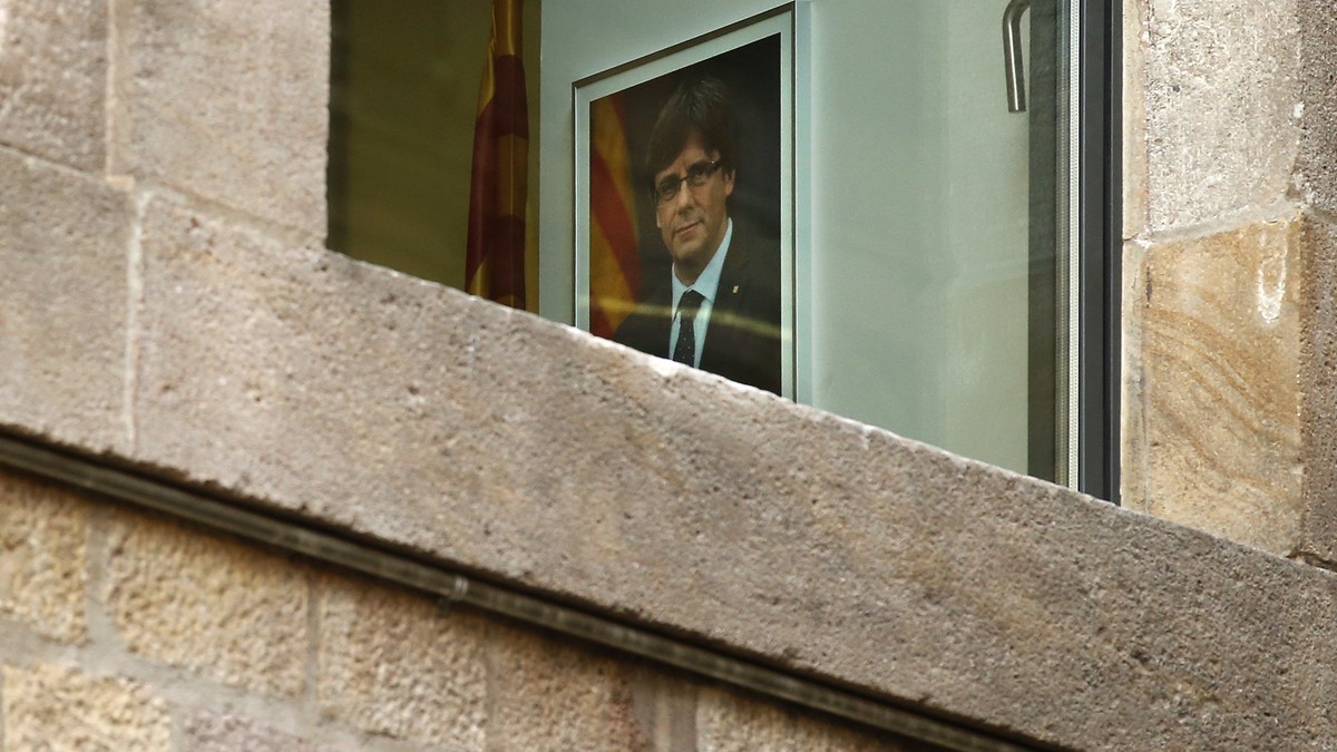 A portrait of ousted regional leader Carles Puigdemont is seen inside the Palau Generalitat in Barcelona, Spain, Monday Oct. 30, 2017. Catalonia's civil servants face their first full work week s ...