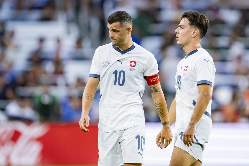 Switzerland's Granit Xhaka, left, reacts next to Switzerland's Ardon Jashari, right, during a Friendly soccer match between USA and Switzerland at the Geodis Park stadium, in Nashville, Tenn ...