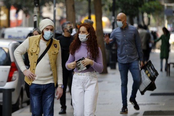 People wear masks to help protect themselves from the coronavirus on Hamra street in Beirut, Lebanon, Monday, Jan. 4, 2021. Lebanon is gearing up for a new nationwide lockdown, as officials vowed Mond ...