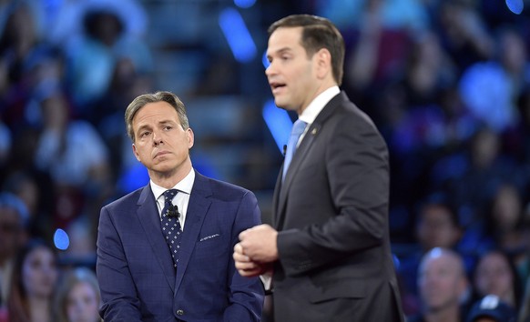 CNN's Jake Tapper listens to Republican Sen. Marco Rubio during a CNN town hall meeting, Wednesday, Feb. 21, 2018, in Sunrise, Fla. Rubio is being challenged by angry students, teachers and parents wh ...