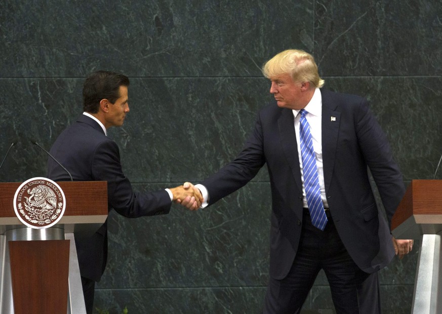 epa05517650 US Republican presidential candidate Donald Trump (R) shakes hands with President of Mexico Enrique Pena Nieto in Los Pinos, Mexico City, Mexico, 31 August 2016. Trump met with the Mexican ...