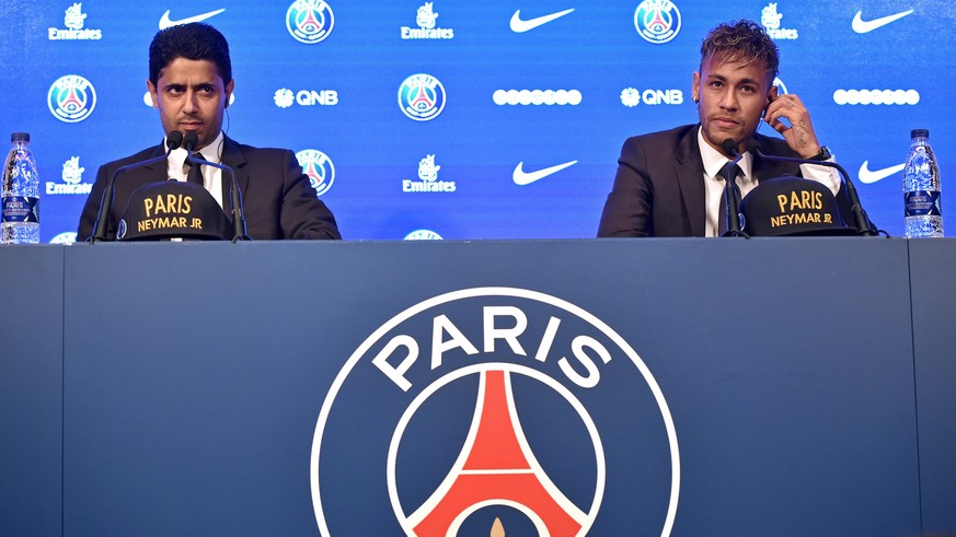 epa06124214 Paris Saint Germain&#039;s chairman and CEO Nasser Al-Khelaif (L) and Brazilian striker Neymar Jr (R) speak to media during a press conference at the Parc des Princes stadium in Paris, Fra ...