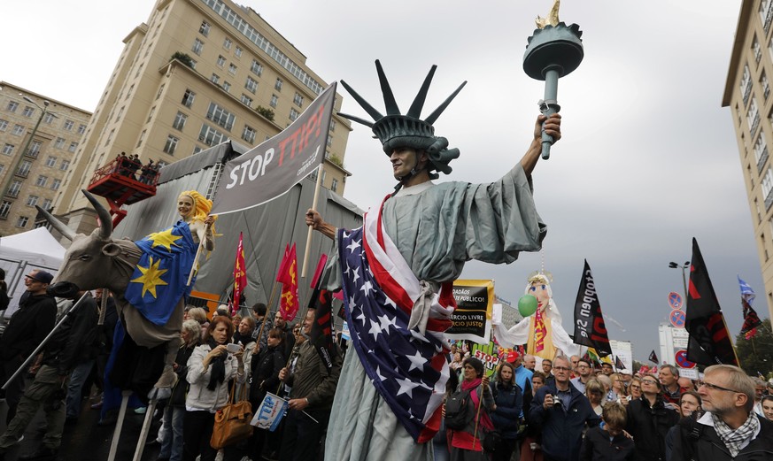 Consumer rights activists take part in a march to protest against the Transatlantic Trade and Investment Partnership (TTIP) and Comprehensive Economic and Trade Agreement (CETA) in Berlin, Germany, Se ...