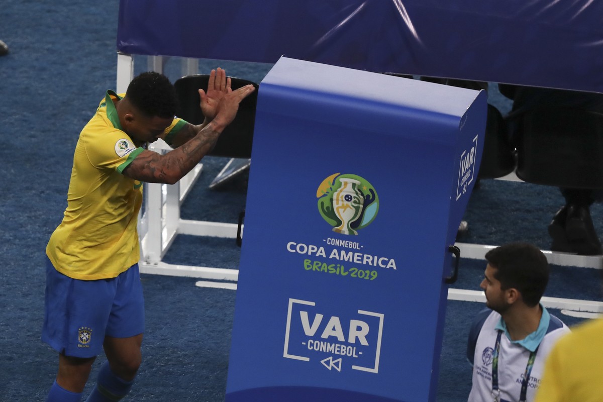 Brazil's Gabriel Jesus punches the VAR monitor after referee Roberto Tobar showed him the red card during the final soccer match of the Copa America against Peru at the Maracana stadium in Rio de ...
