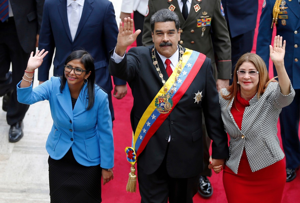 FILE - Venezuela's President Nicolas Maduro, then Constituent National Assembly President Delcy Rodriguez, left, and first lady Cilia Flores, wave as they arrive to the National Assembly, in Cara ...