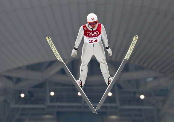 Tim Hug, of Switzerland, soars through the air during the trial jump in the nordic combined competition at the 2018 Winter Olympics in Pyeongchang, South Korea, Wednesday, Feb. 14, 2018. (AP Photo/Mat ...