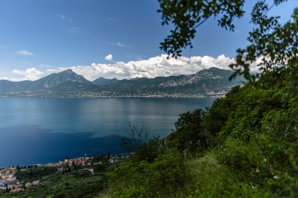 view of lake garda algo water with mountains coasts of lake garda landscape of lake garda with mountains and nature near Torri del Benaco near Lake Garda Verona Veneto Italy Model Released Property Re ...